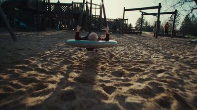 a person laying on a surfboard in the sand