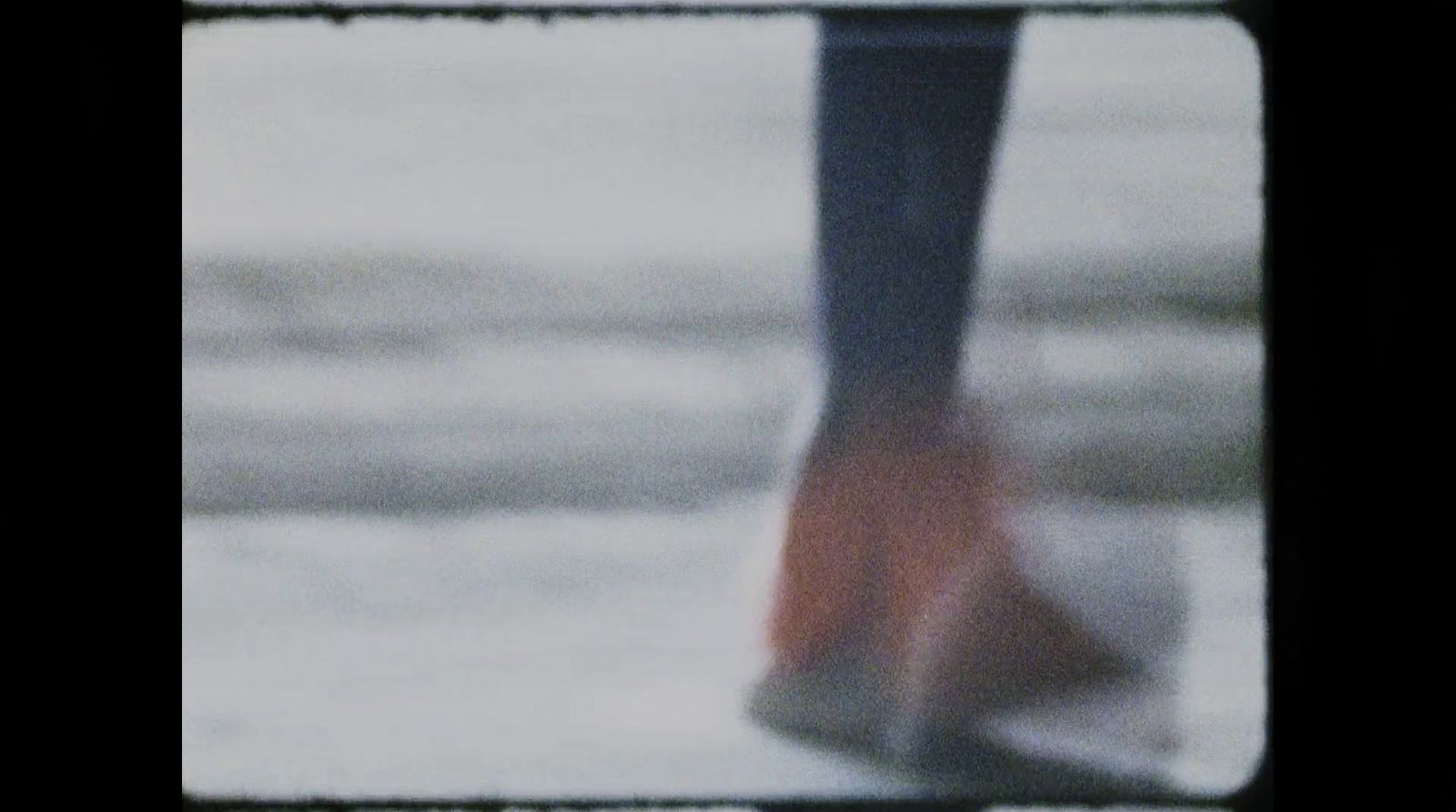 a blurry picture of a person's feet in high heels