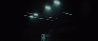 a dark room with three lights on the ceiling