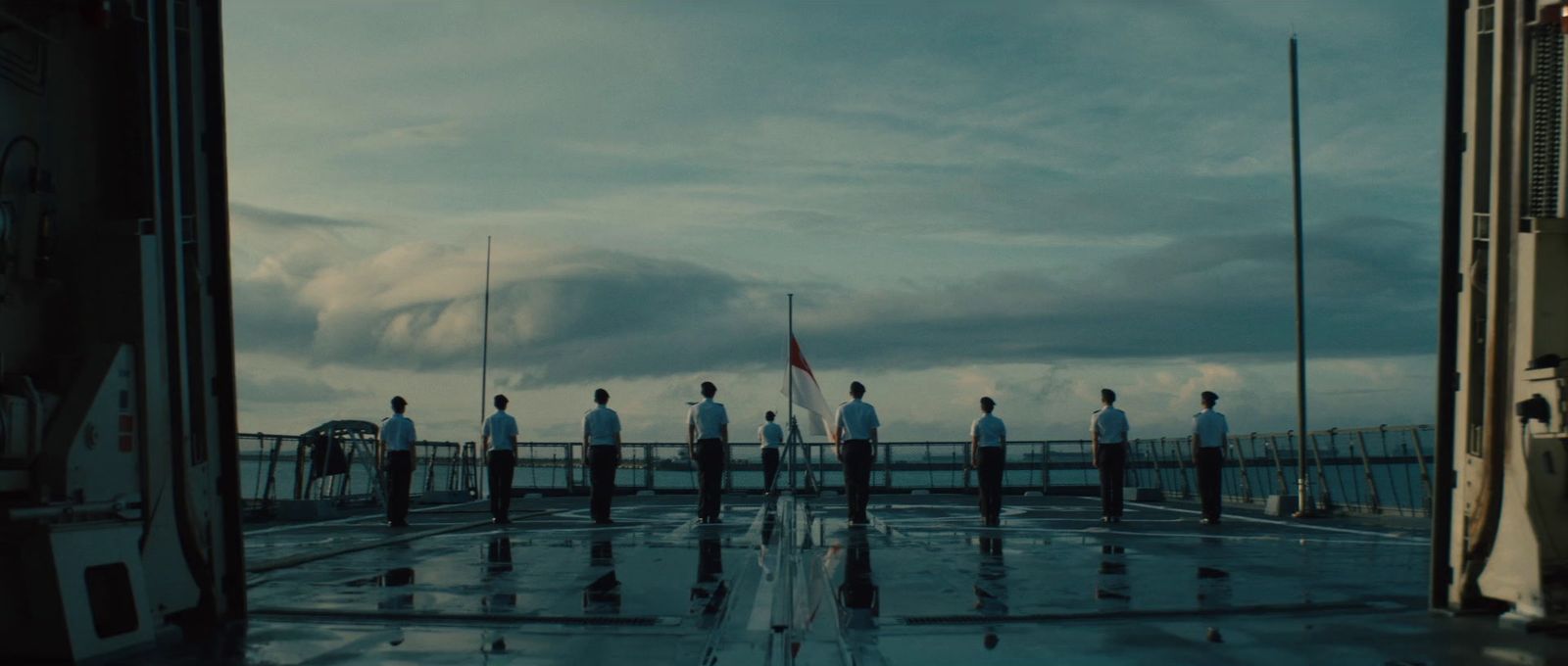 a group of men standing on top of a boat