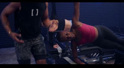 a woman is doing exercises on a machine