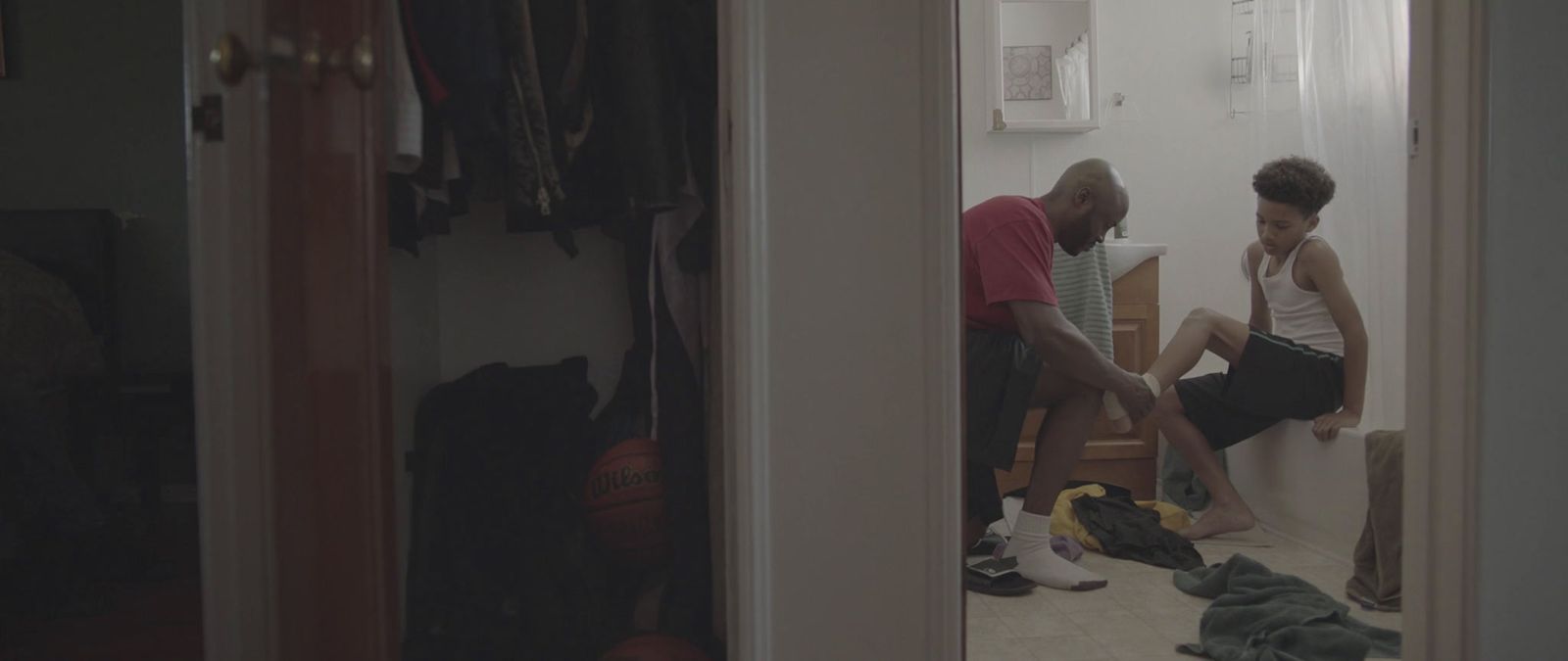 a man and a woman sitting on a toilet in a bathroom