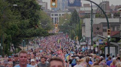 a large group of people walking down a street