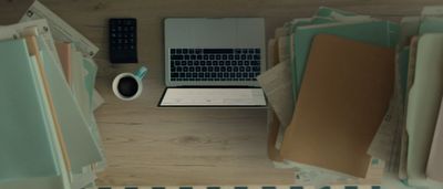 a laptop computer sitting on top of a wooden desk