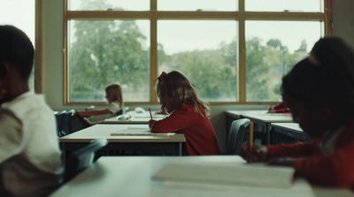 a group of children sitting at desks in a classroom