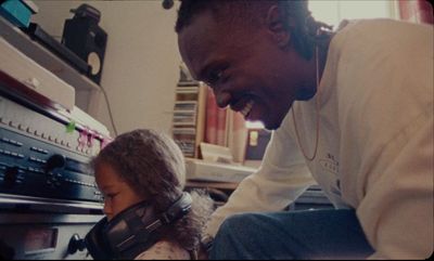 a man and a little girl are looking at a radio