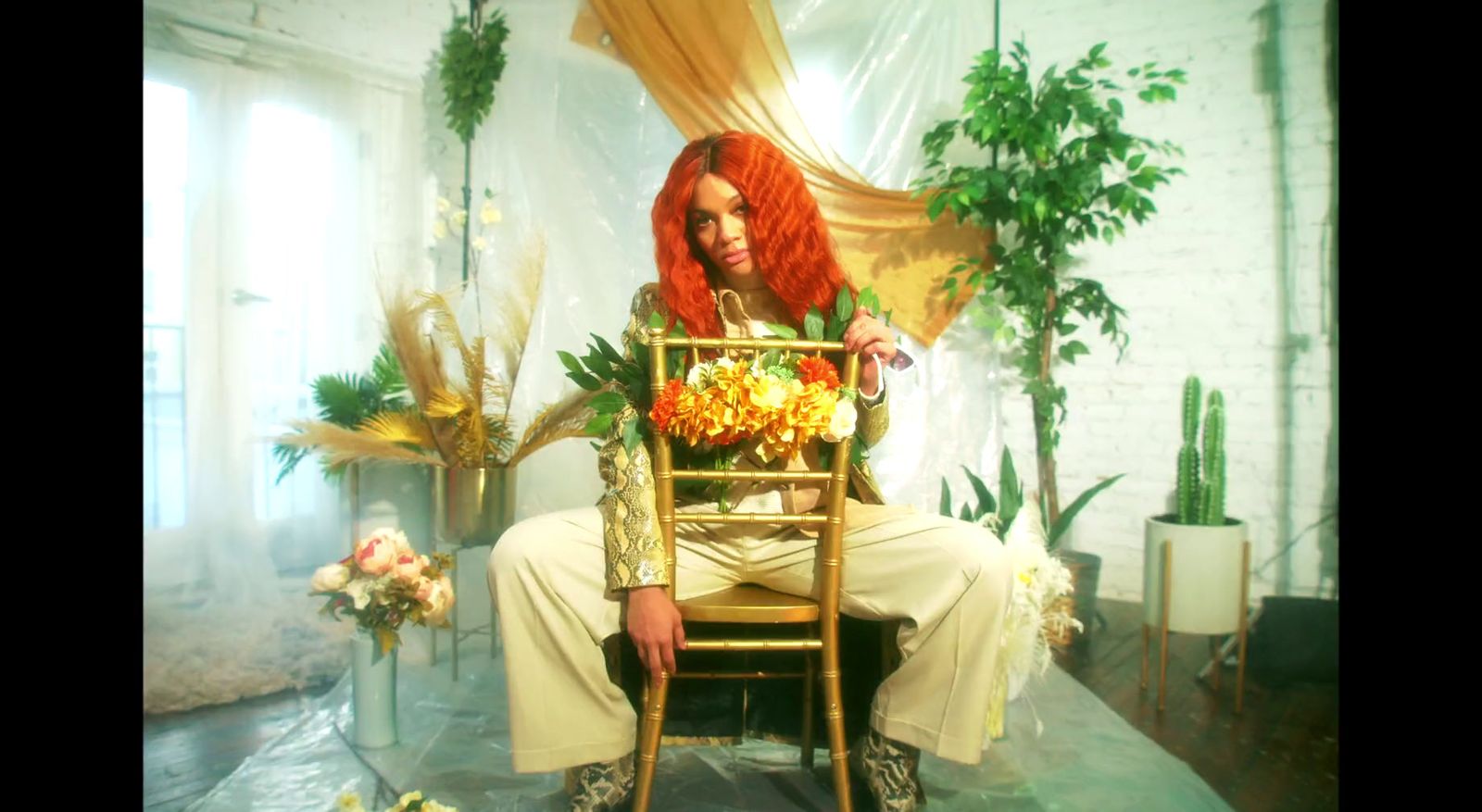 a woman with red hair sitting on a chair