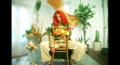 a woman with red hair sitting on a chair