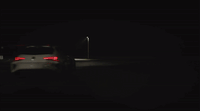 a car is driving in the dark at night