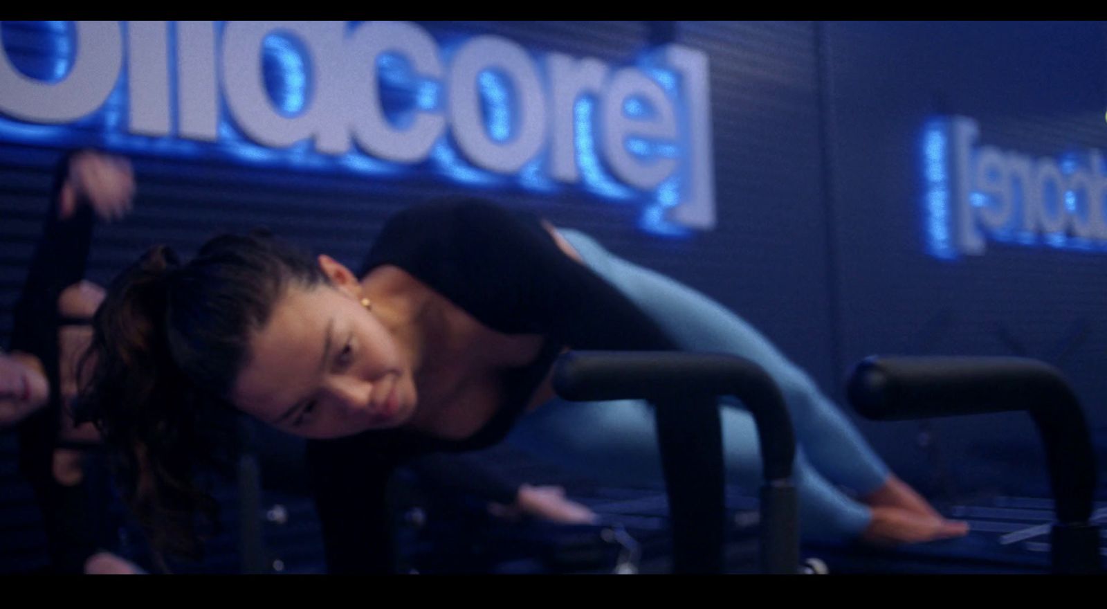 a woman doing a handstand on a machine