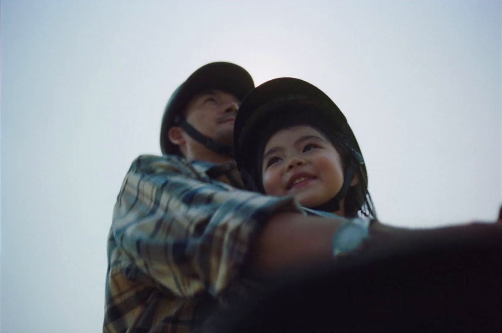 a man and a little girl standing next to each other