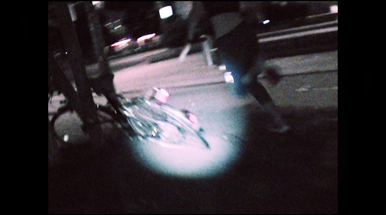 a blurry photo of a bicycle parked on the side of the road