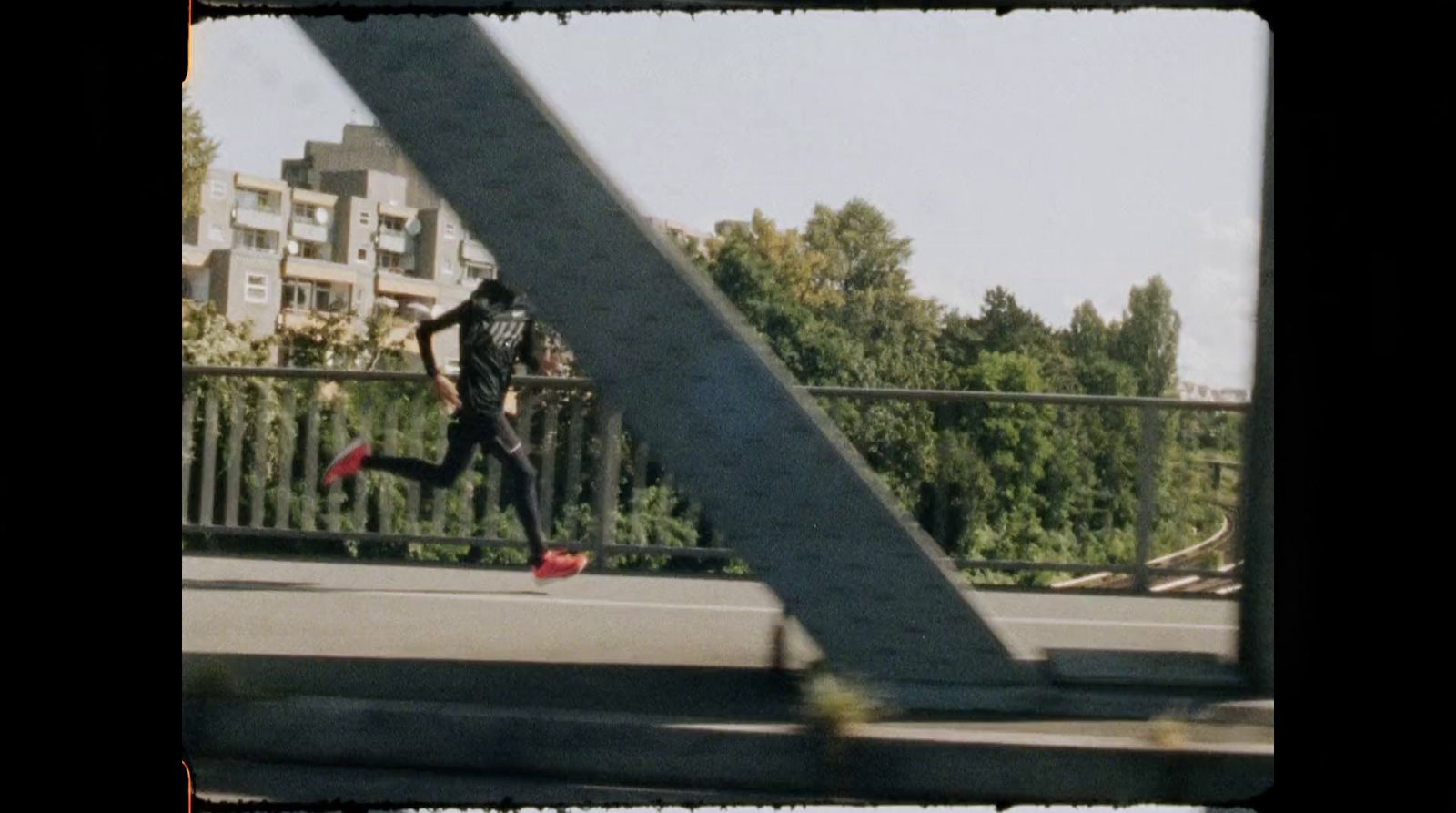 a man riding a skateboard across a bridge