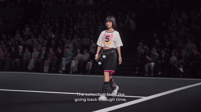 a woman standing on a tennis court holding a racquet