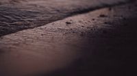 a close up of a wet surface of a beach