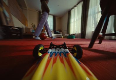 a toy car on the floor of a living room