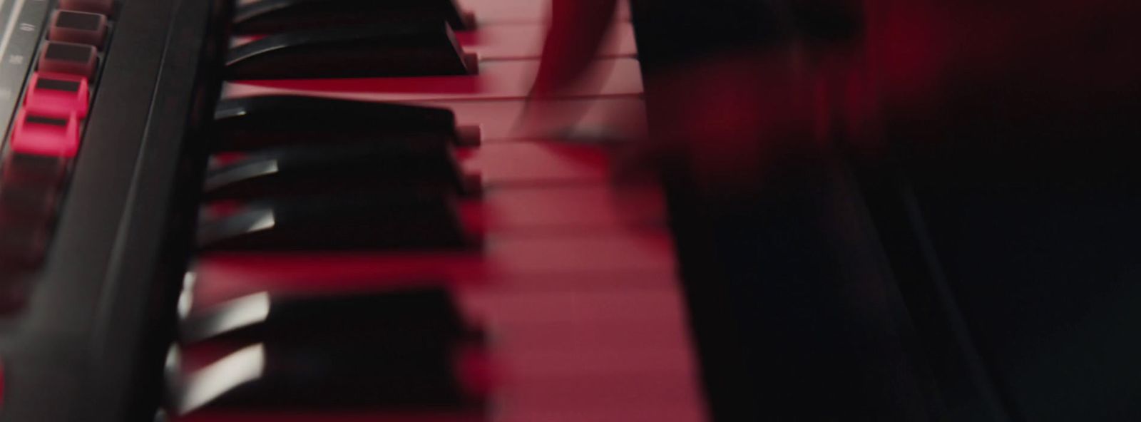 a close up of a red piano keyboard