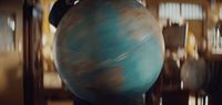 a large blue ball sitting on top of a wooden table