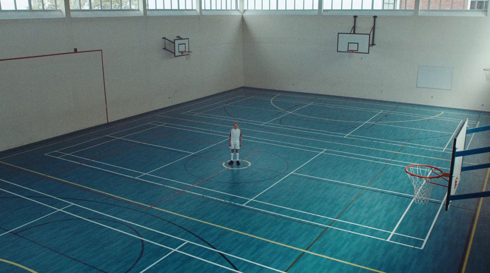 an indoor basketball court with a basketball hoop