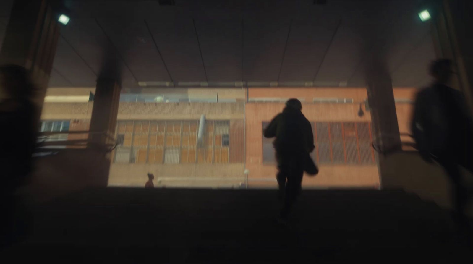 a blurry photo of a person walking down a street