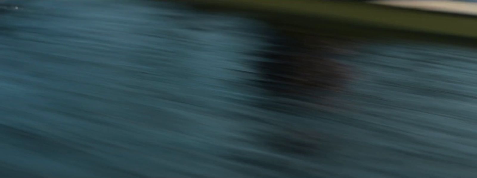 a blurry photo of a person standing on a dock