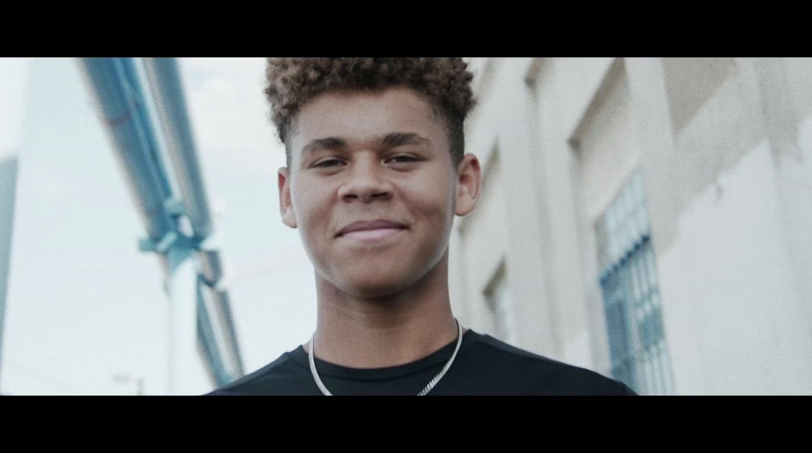 a close up of a person wearing a necklace