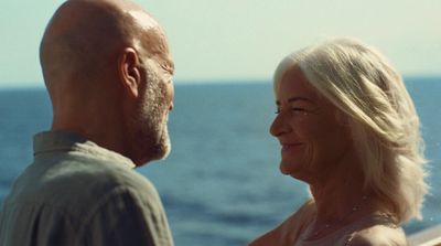 a man and a woman standing next to each other on a boat