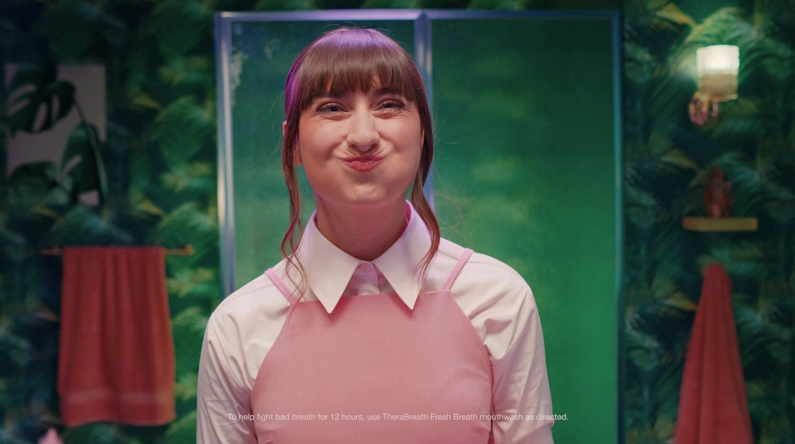 a woman wearing a pink apron and smiling