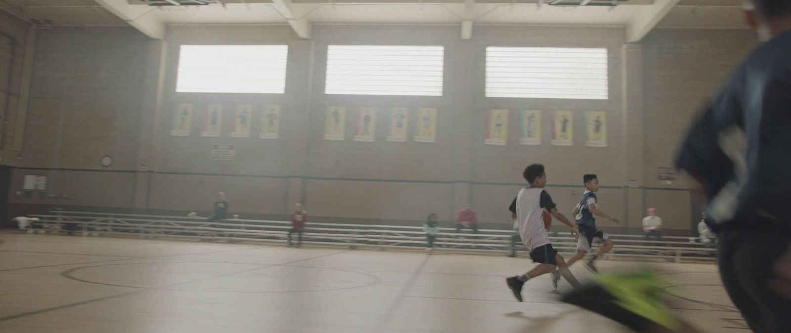 a group of young men playing a game of basketball