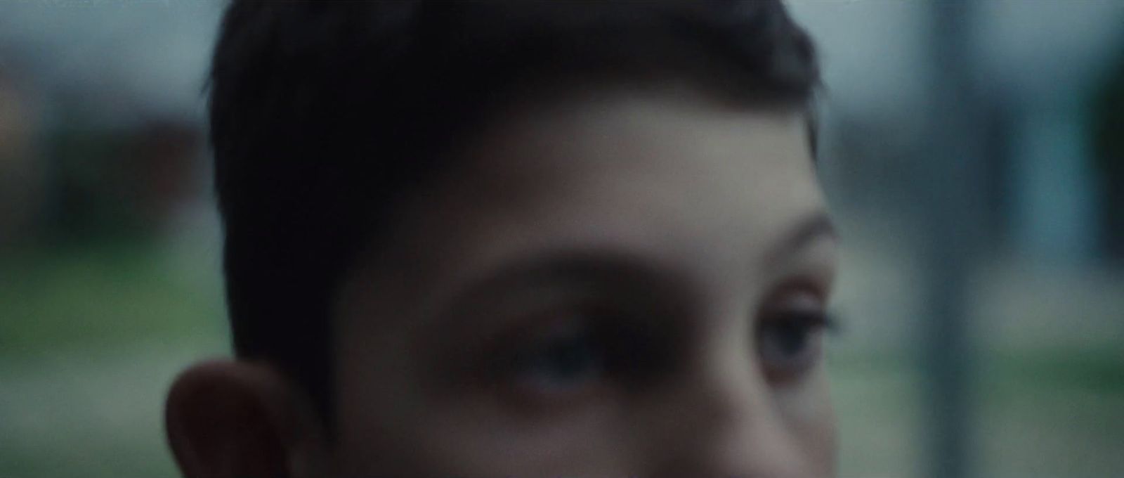 a close up of a person's face with a blurry background