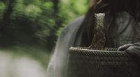 a person with long hair carrying a basket