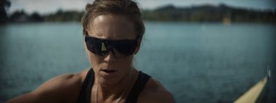 a woman wearing sunglasses on a boat in the water