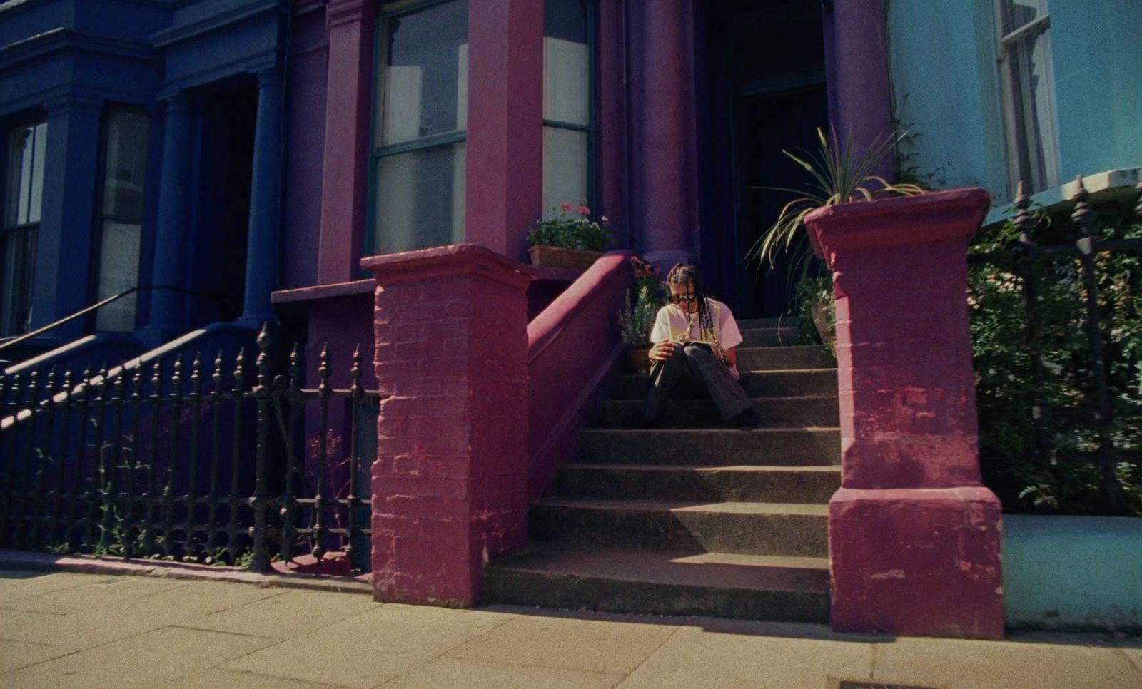 a man sitting on the steps of a building