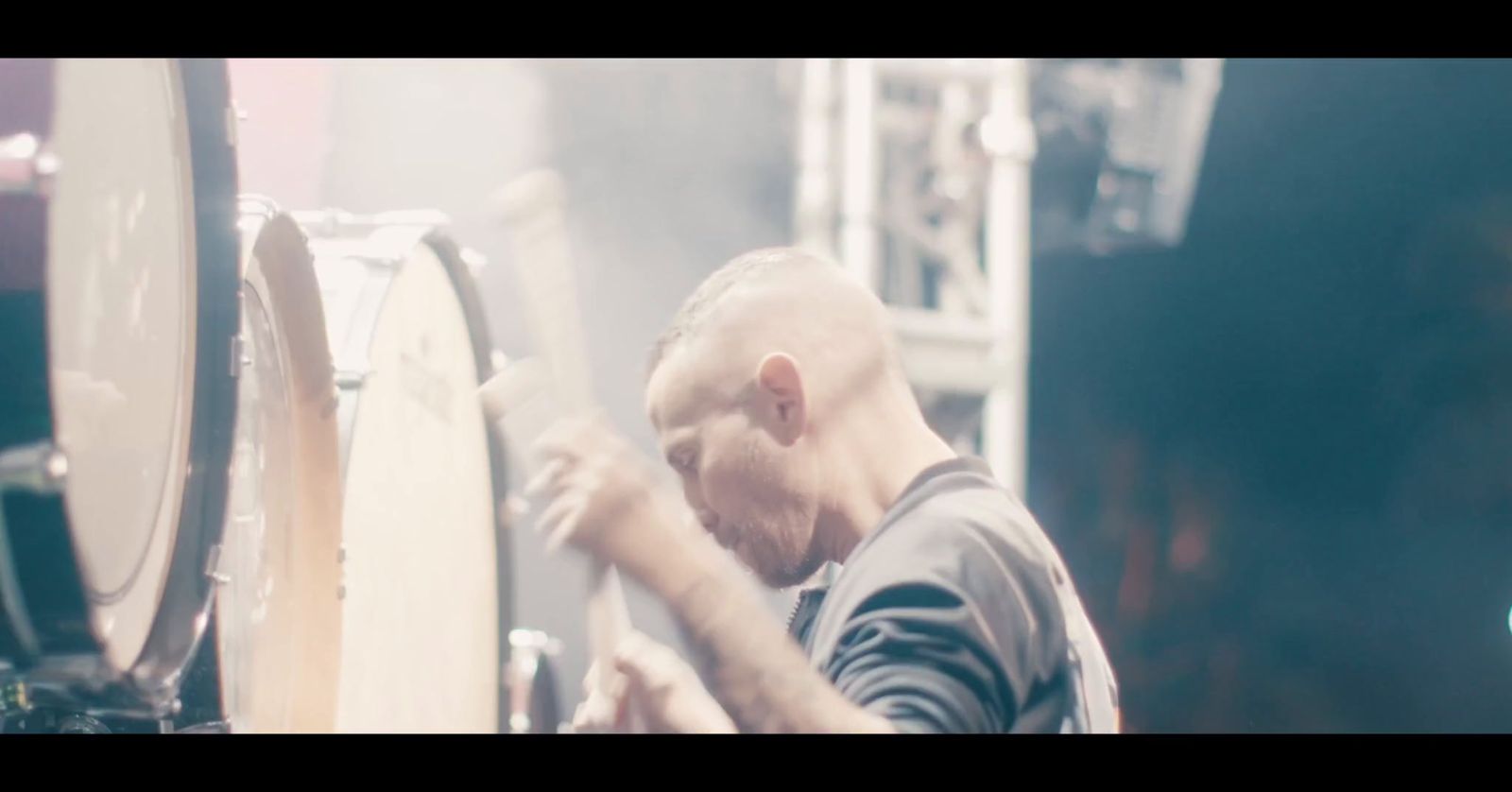 a man is playing drums on a stage