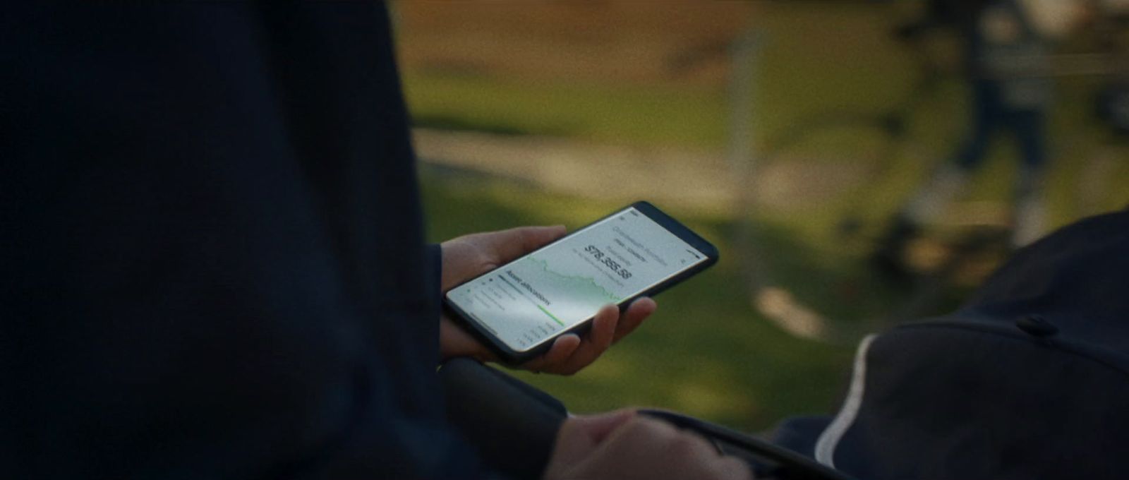 a person holding a cell phone in their hand