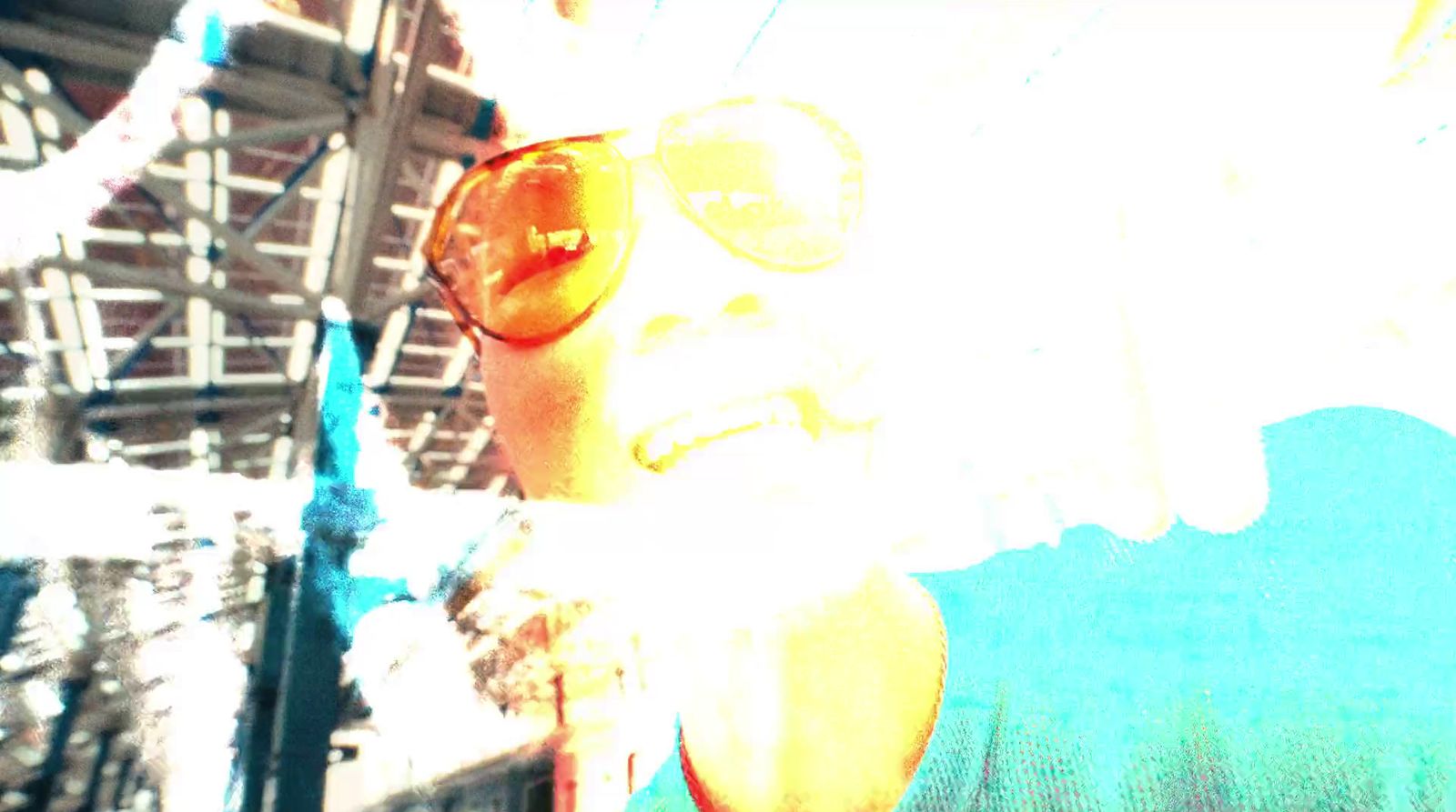 a woman wearing sun glasses and a blue shirt