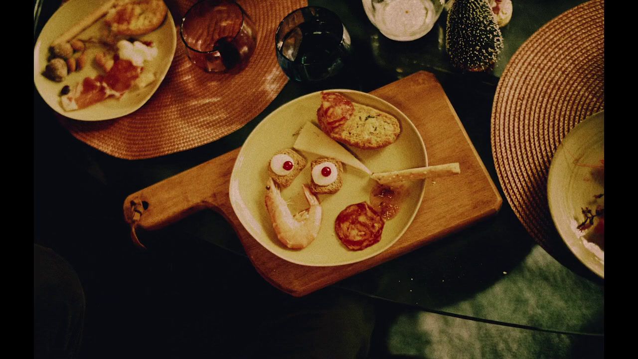 a table topped with plates of food and glasses of wine