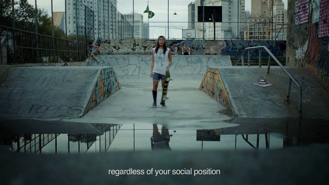 a woman standing on a skateboard ramp in a skate park