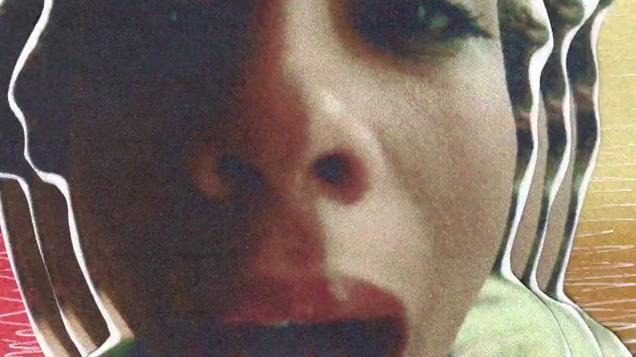 a close up of a woman's face with a creepy look on her face