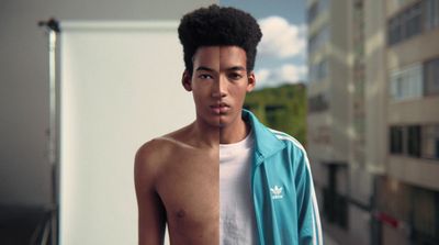 a young man standing in front of a tall building