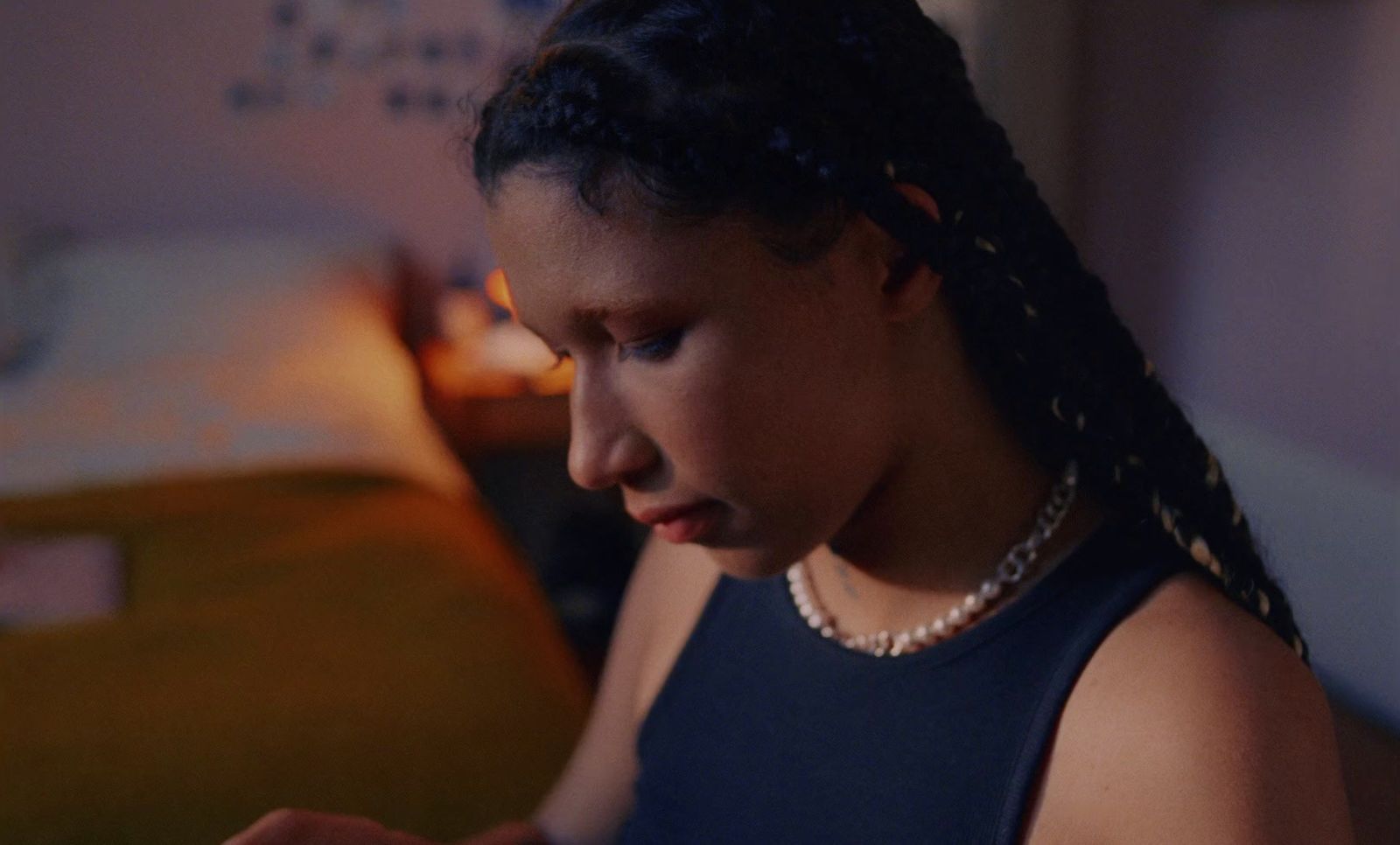 a woman with braids looking at a cell phone