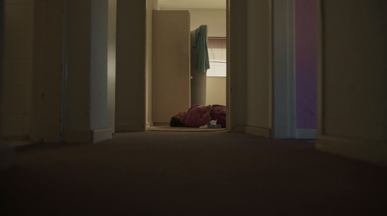 a person laying on the floor in a hallway