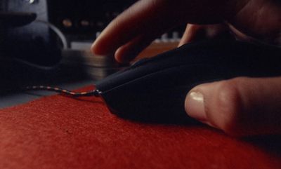 a person is working on a piece of fabric