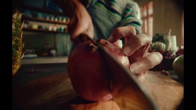 a person cutting up an apple on a cutting board