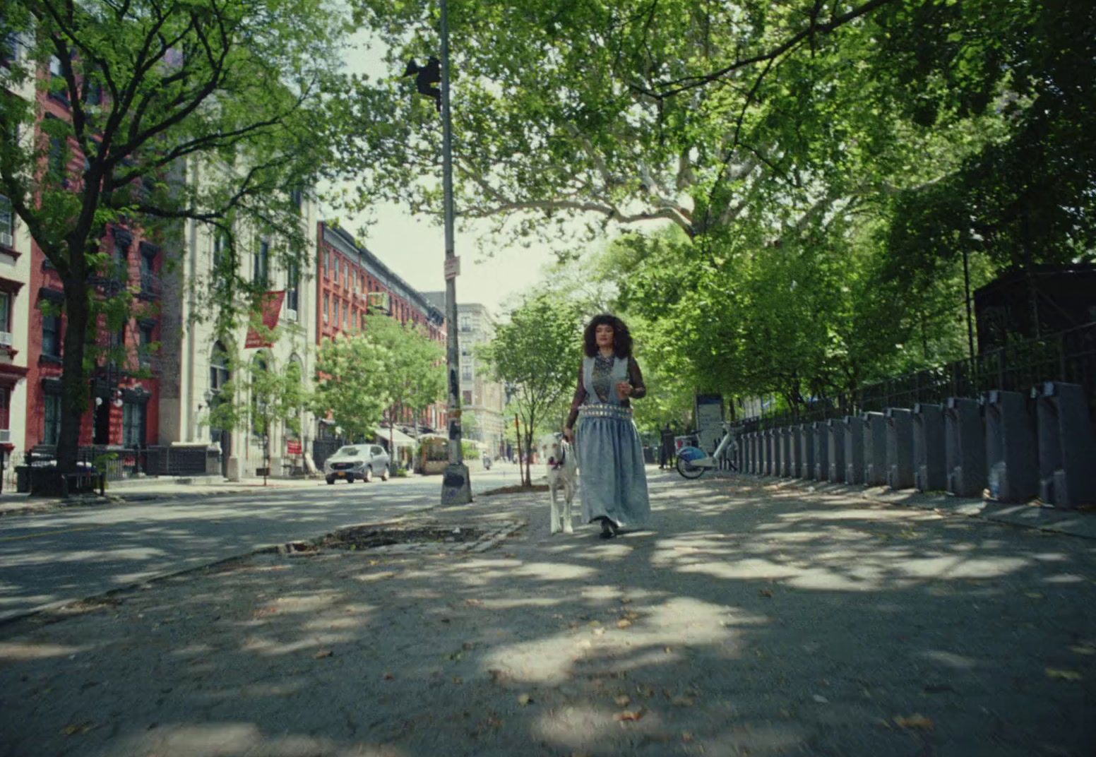 a woman is walking down the street with a suitcase