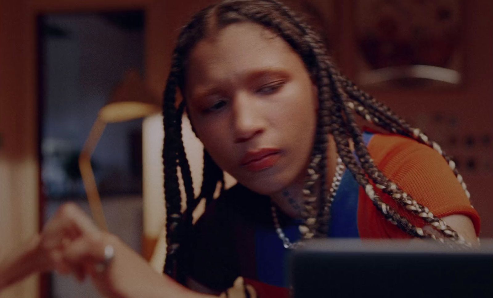 a woman with dreadlocks looking at a laptop