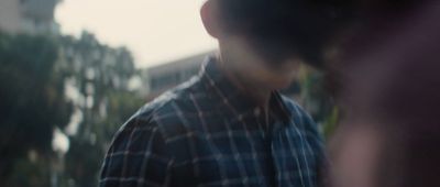 a blurry image of a man in a plaid shirt