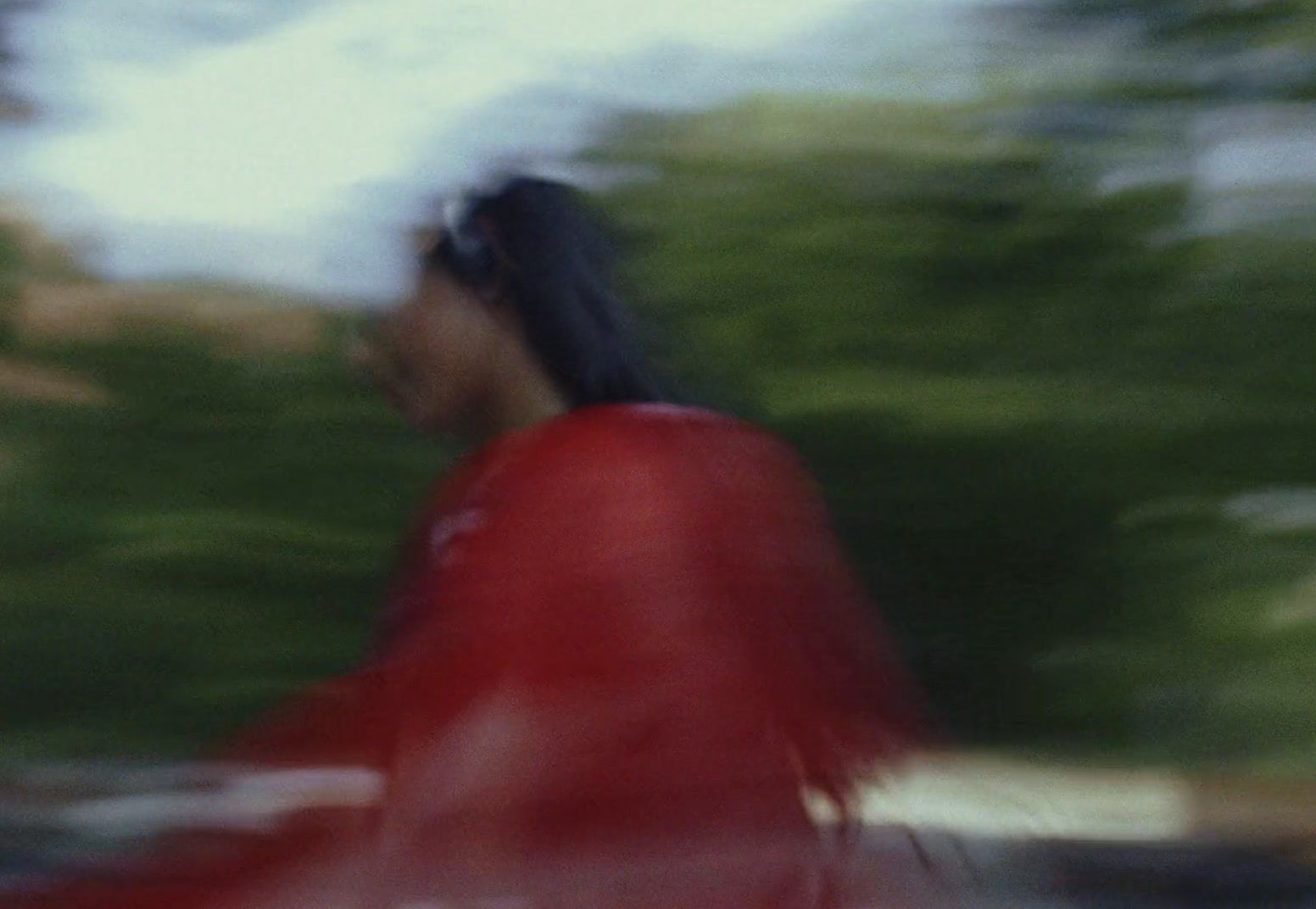 a blurry photo of a woman in a red dress