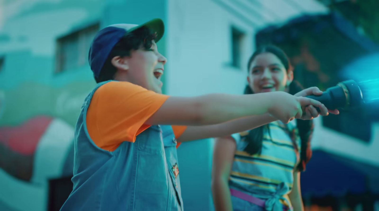 a boy and a girl are playing with a light saber