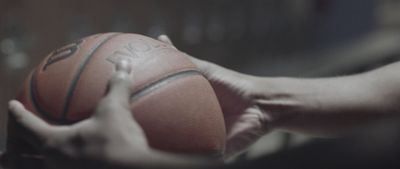 a close up of a person holding a basketball